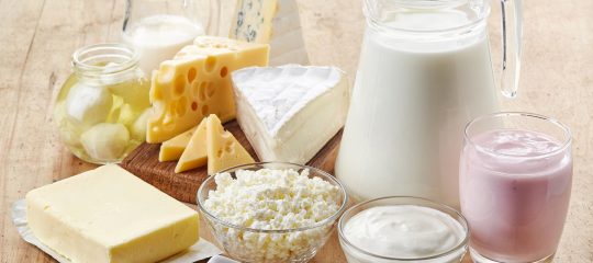 Various fresh dairy products on wooden background